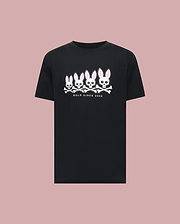 The Psycho Bunny MENS ARCHIVE GRADIANT BUNNY GRAPHIC TEE (MT0200029) showcases four iconic white and pink Bunny skull and crossbones with "BOLD SINCE 2005" text, set against a plain light pink background. (1)