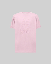 The Psycho Bunny MENS REMY GRAPHIC TEE (MT0200059) is a light pink Pima cotton short-sleeve tee with an embossed bunny logo above two crossed bones on the front, shown against a plain gray background. (1)