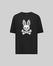 The Psycho Bunny MENS RYDER OVERSIZED FIT TEE (MT0200062) is a black Pima cotton shirt featuring a bold white bunny head with long ears over a skull and crossbones, all set on a plain gray background.
