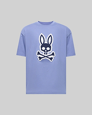 The Psycho Bunny MENS RYDER OVERSIZED FIT TEE (MT0200062) is a light purple premium tee with a bold black and white bunny skull and crossbones graphic on the front, shown against a plain gray background. (1)
