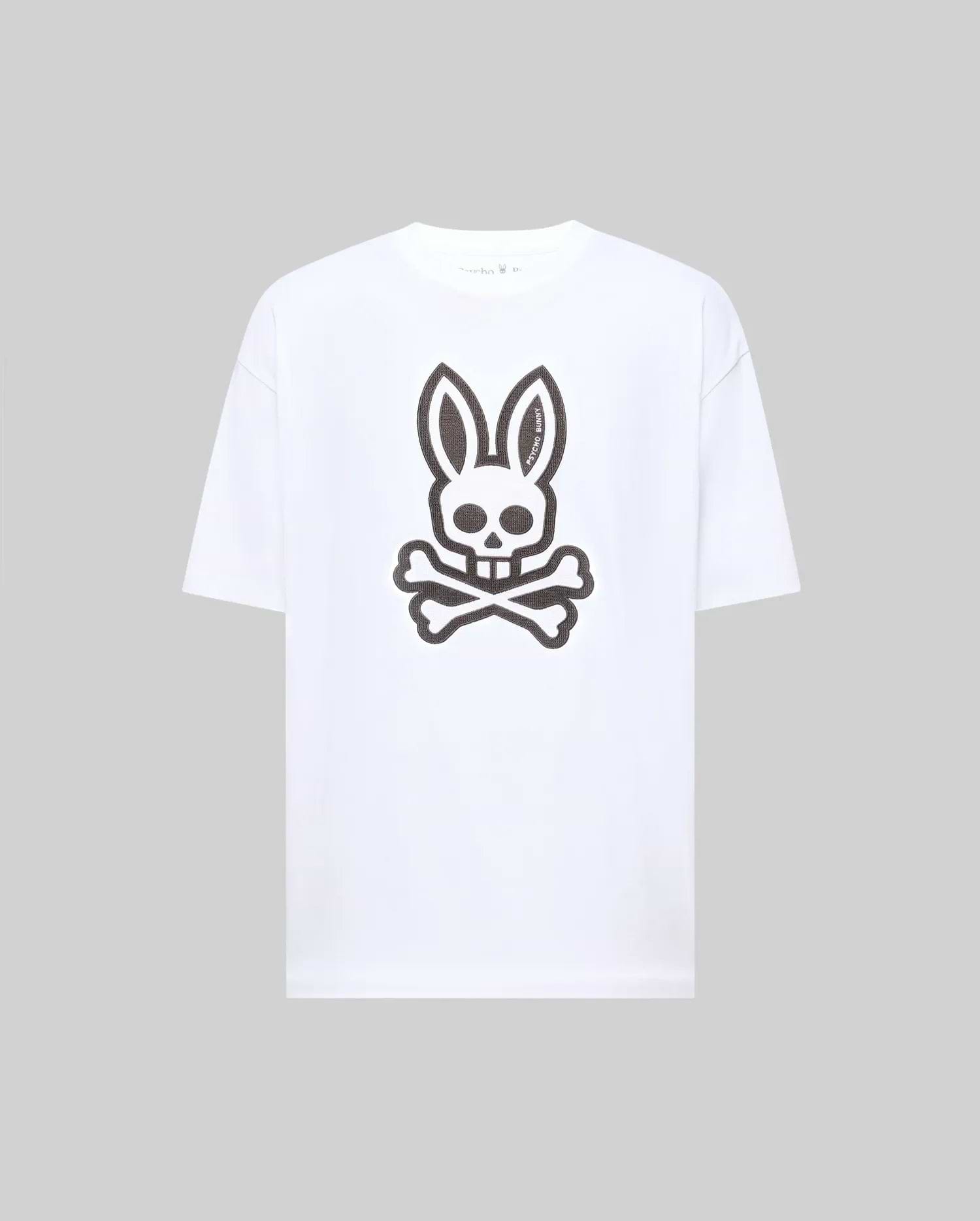 The Psycho Bunny MENS RYDER OVERSIZED FIT TEE (MT0200062) is a premium white Pima cotton T-shirt with an oversized fit, featuring a large black bunny skull and crossbones graphic on the front.
