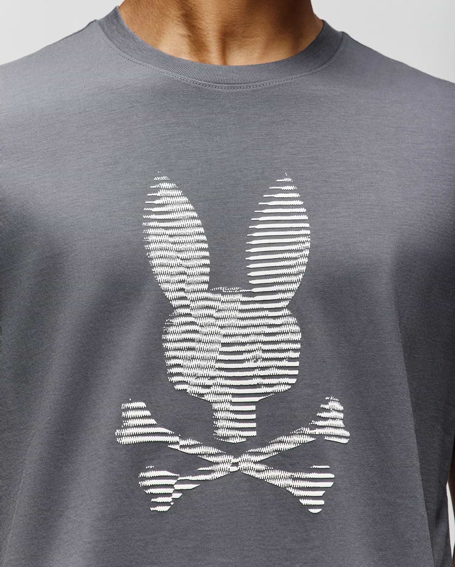 A close-up of the Psycho Bunny MENS GRANT BUNNY GRAPHIC TEE (MT0200081), crafted in Peru from soft Pima cotton, featuring a white bunny head with long ears above crossed bones for a playful twist on the classic graphic. (3)