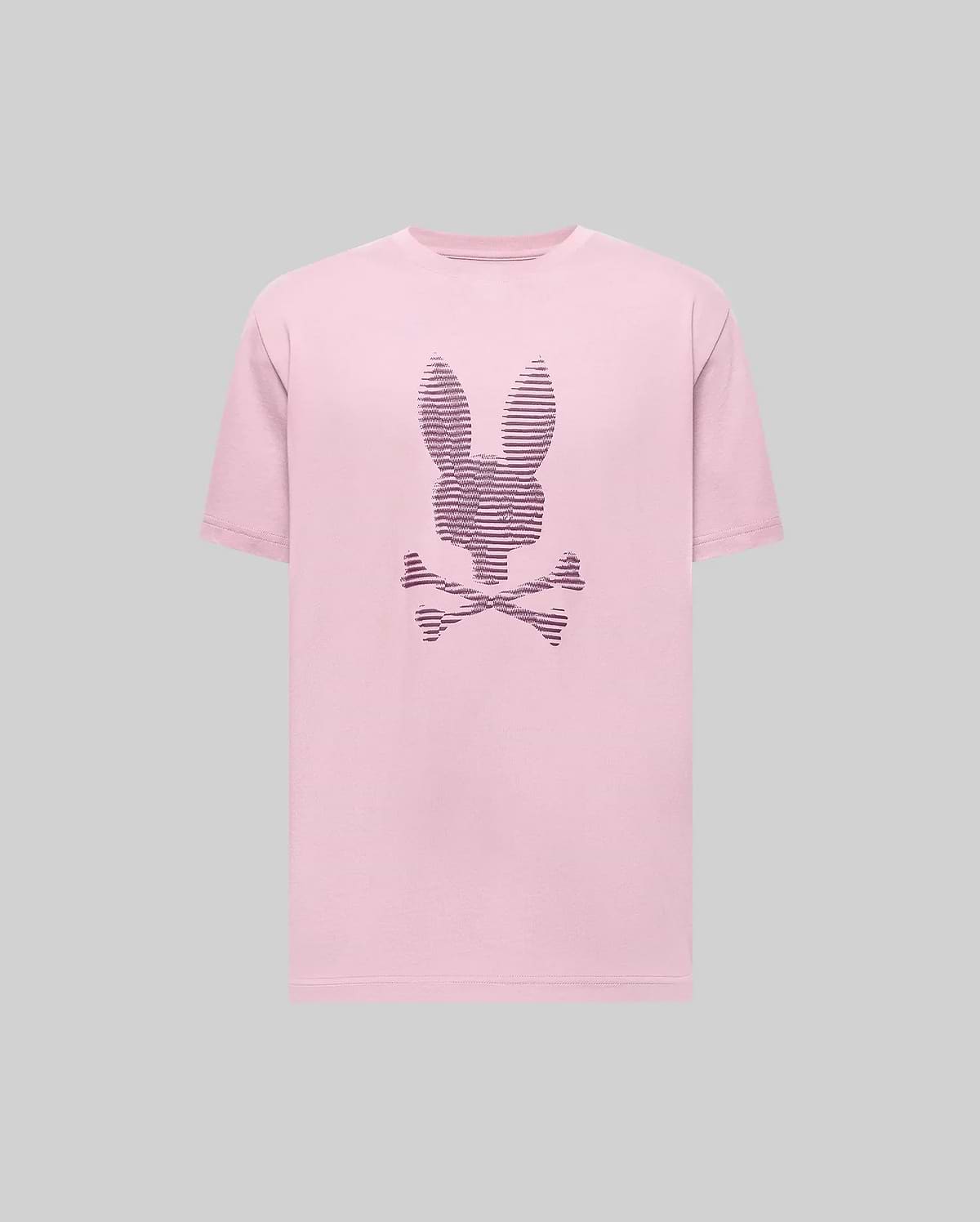 The Psycho Bunny MENS GRANT BUNNY GRAPHIC TEE (MT0200081) is a light pink Pima cotton tee featuring a dark purple outlined bunny head above crossed bones, showcased on a plain gray background. (1)