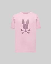 The Psycho Bunny MENS GRANT BUNNY GRAPHIC TEE (MT0200081) is a light pink Pima cotton tee featuring a dark purple outlined bunny head above crossed bones, showcased on a plain gray background. (1)