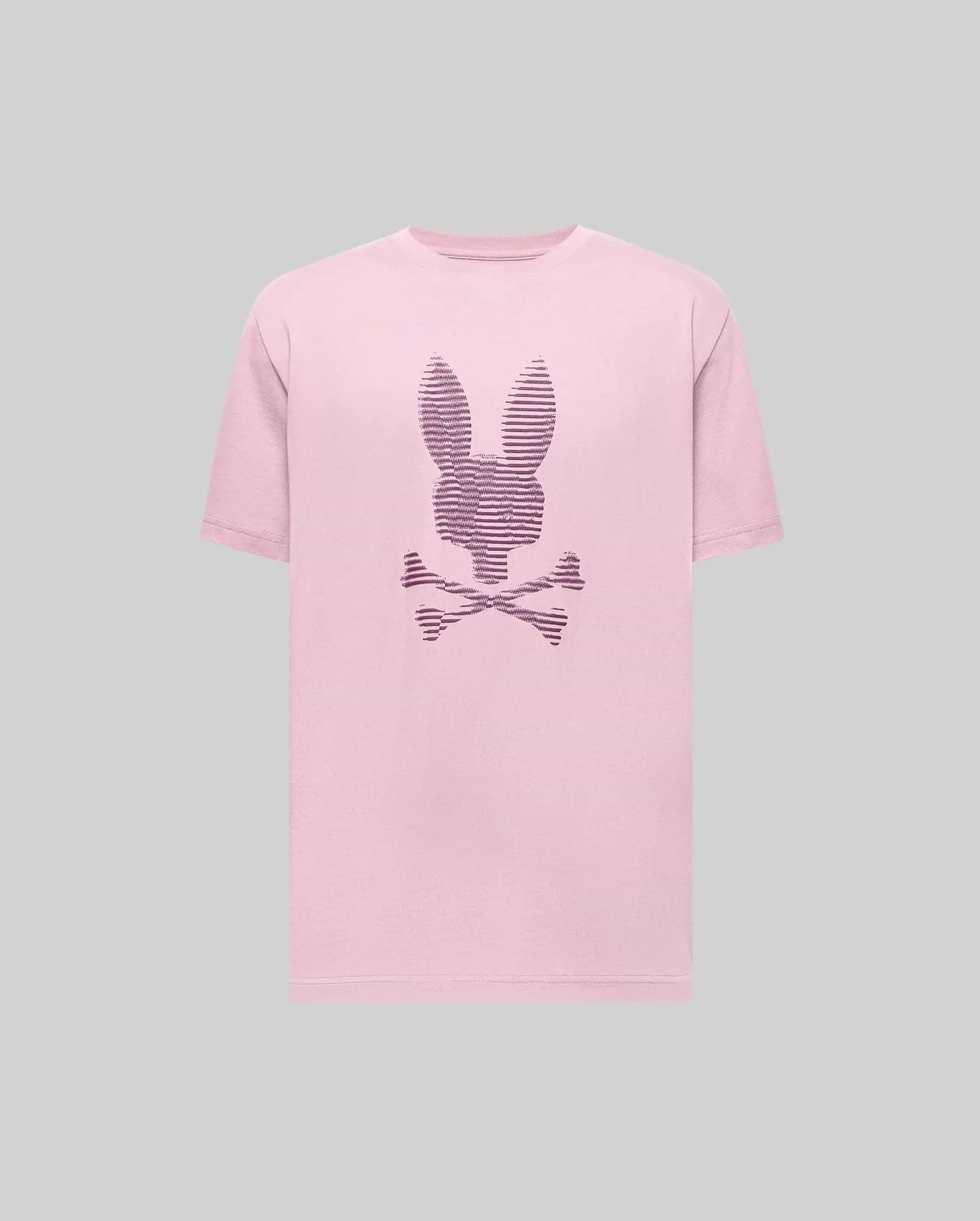 The Psycho Bunny MENS GRANT BUNNY GRAPHIC TEE (MT0200081) is a light pink Pima cotton tee featuring a dark purple outlined bunny head above crossed bones, showcased on a plain gray background. (1)