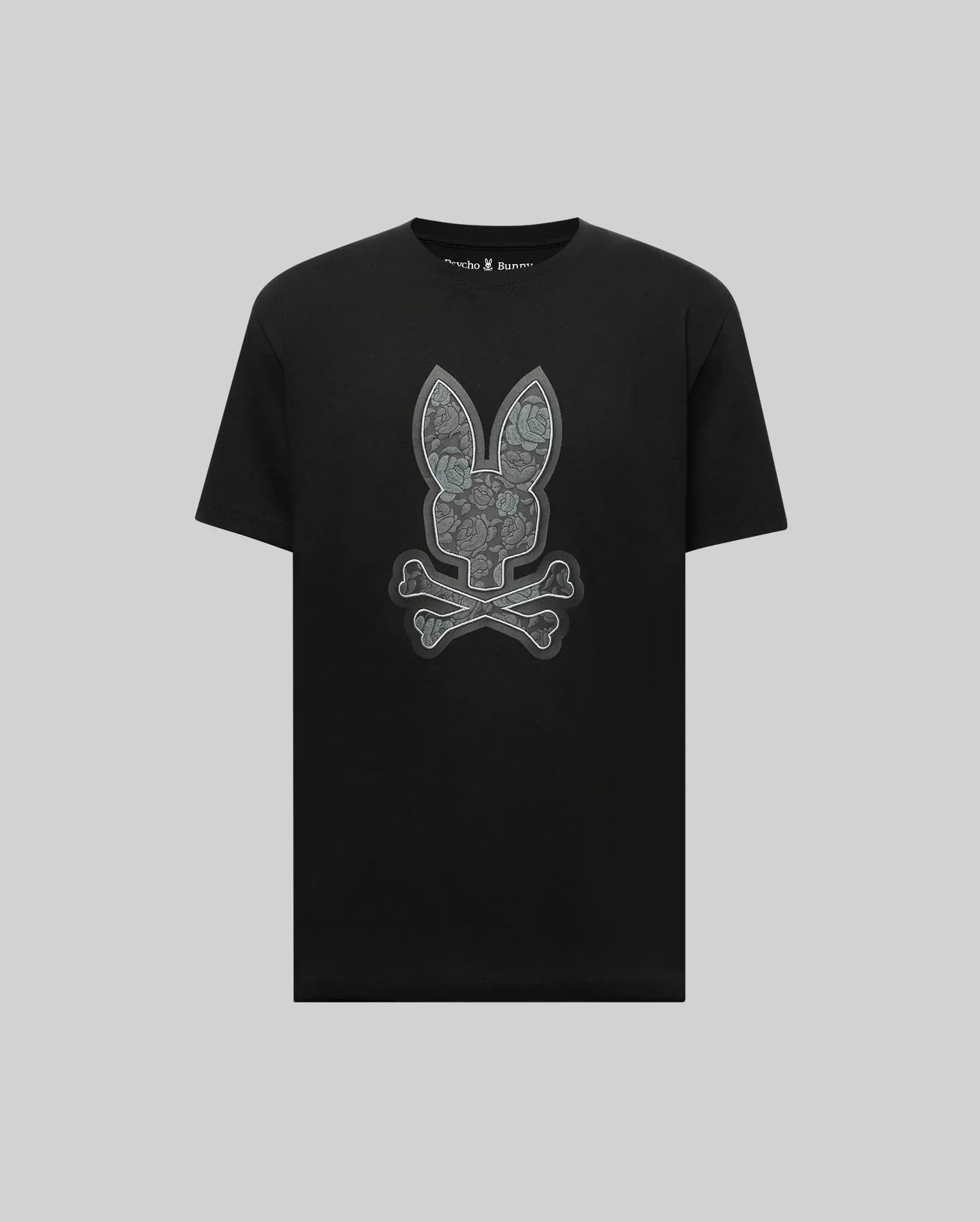 The Psycho Bunny MENS ROWEN BUNNY GRAPHIC TEE (MT0200101) features a large gray bunny face with crossed bones in graphic style, crafted from soft Pima cotton and set against a light gray background.