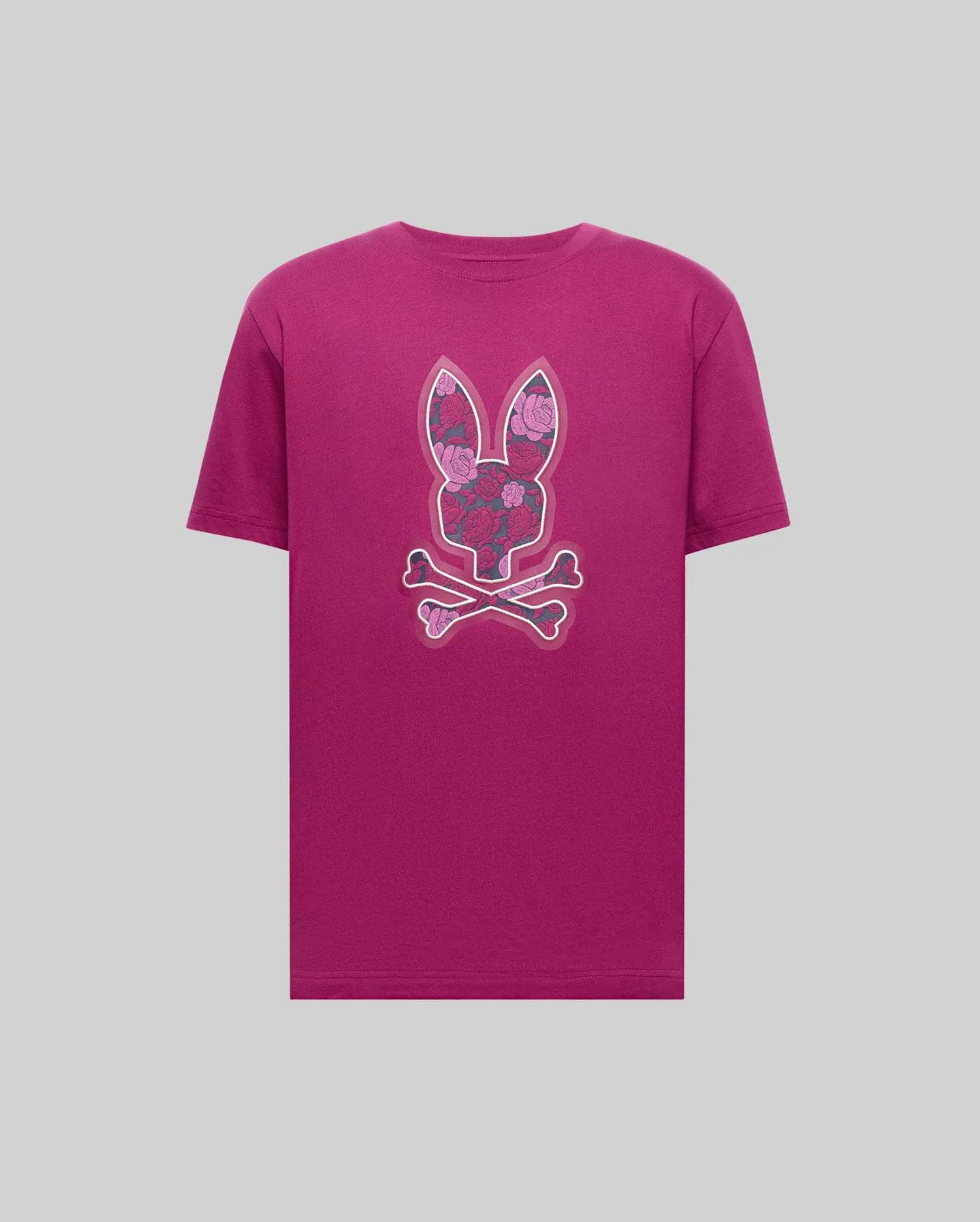 The Psycho Bunny MENS ROWEN BUNNY GRAPHIC TEE (MT0200101) is a magenta Pima cotton tee featuring a bold floral-patterned bunny head above crossed bones, displayed on a simple gray backdrop. (1)