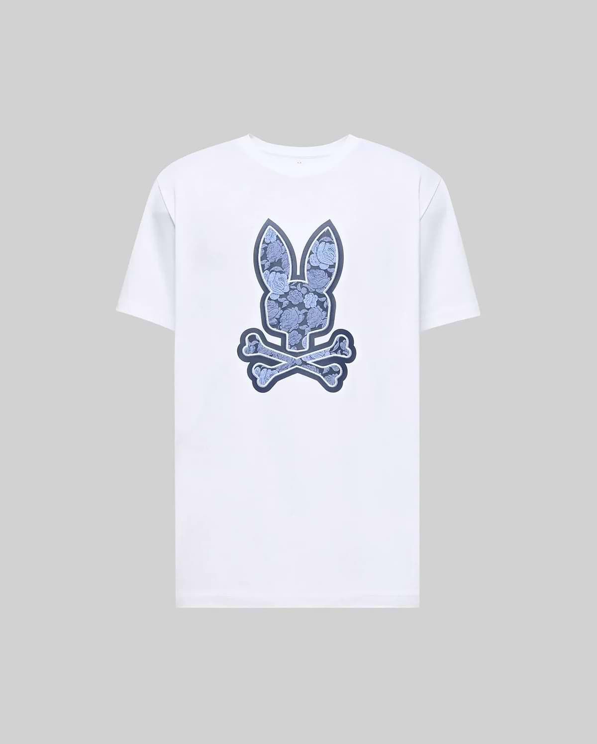 The Psycho Bunny MENS ROWEN BUNNY GRAPHIC TEE (MT0200101) is a white short-sleeve shirt with a large blue bunny head above crossed bones graphic on the front, shown on a plain gray background. (1)