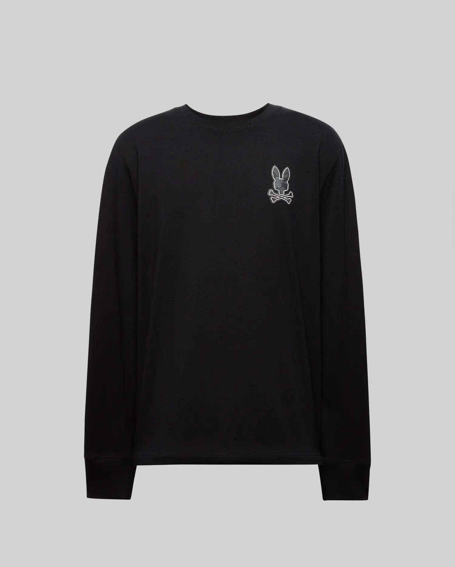 The MENS ROWEN GRAPHIC TEE - MT0200103 by Psycho Bunny is a black long sleeve crewneck featuring a small white outlined cartoon bunny patch on the left chest, shown against a plain light gray background. (6)