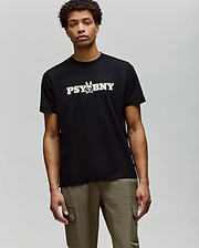 A man wears the Psycho Bunny MENS WADE GRAPHIC TEE (MT0200105), a regular fit black tee with "PSYBNY" and a small bunny graphic, plus olive green cargo pants. The 100% cotton shirt offers comfort against a plain background. (2)