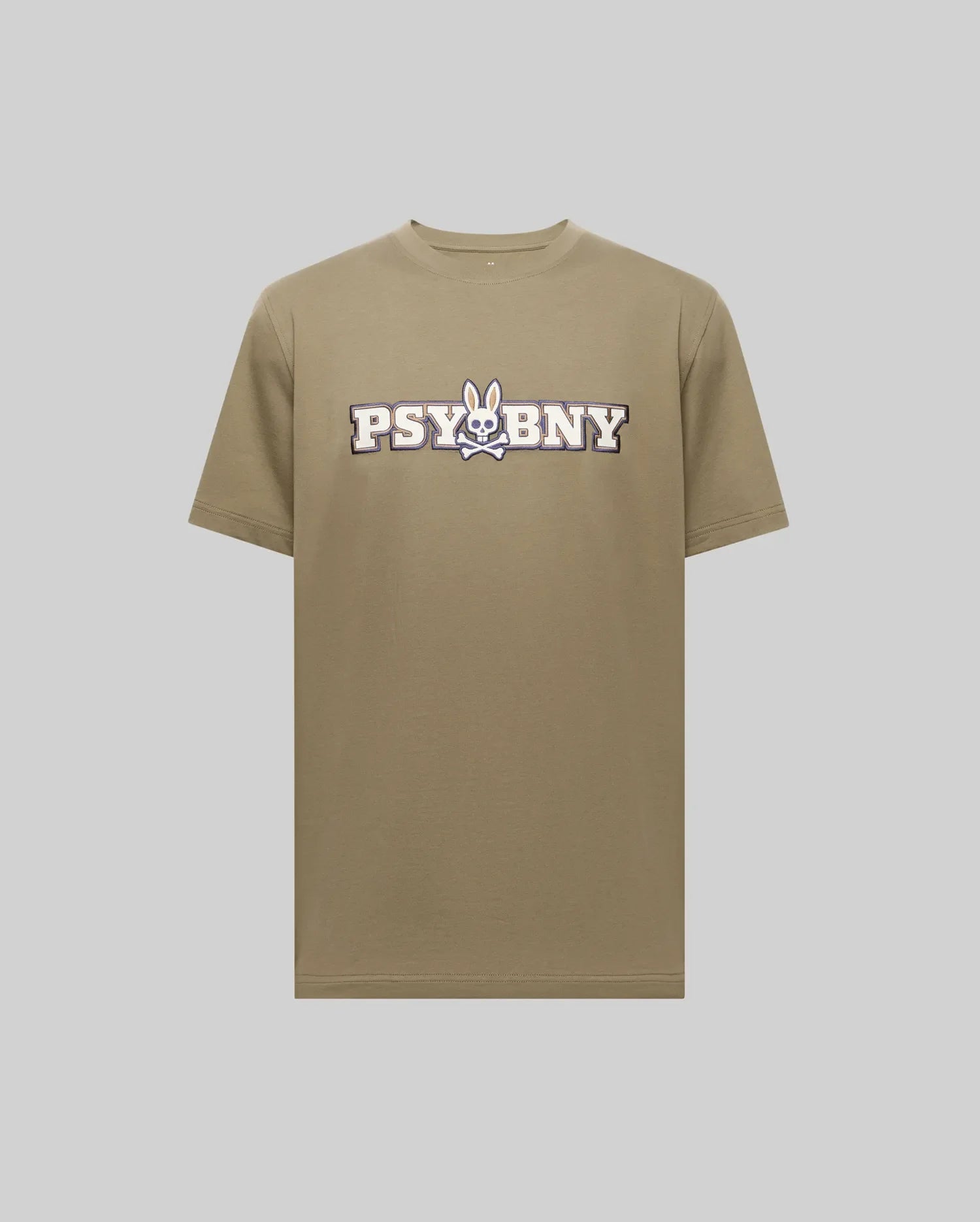 The Psycho Bunny MENS WADE GRAPHIC TEE - MT0200105 is a khaki 100% cotton shirt showcasing "PSYBNY" text and a cartoon bunny skull and crossbones graphic at the center, set against a plain light gray background. (1)