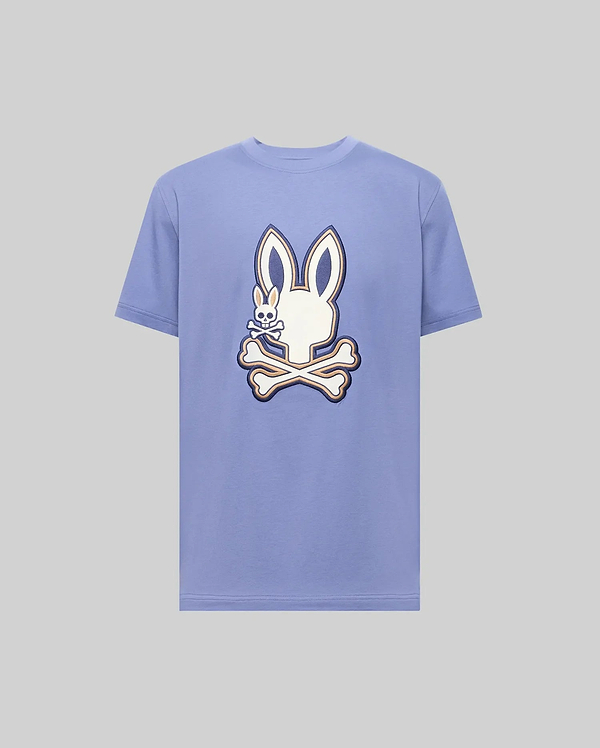 The Psycho Bunny MENS WADE GRAPHIC TEE (MT0200106) is a light purple 100% cotton shirt featuring a large white cartoon bunny head with crossbones on the front.