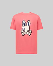The Psycho Bunny MENS WADE GRAPHIC TEE - MT0200106 is a light gray, 100% cotton, short-sleeve shirt with a large embroidered pink bunny head and crossbones, outlined in dark blue and centered on the chest. (1)