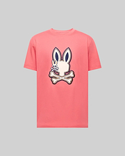 The Psycho Bunny MENS WADE GRAPHIC TEE - MT0200106 is a light gray, 100% cotton, short-sleeve shirt with a large embroidered pink bunny head and crossbones, outlined in dark blue and centered on the chest. (1)