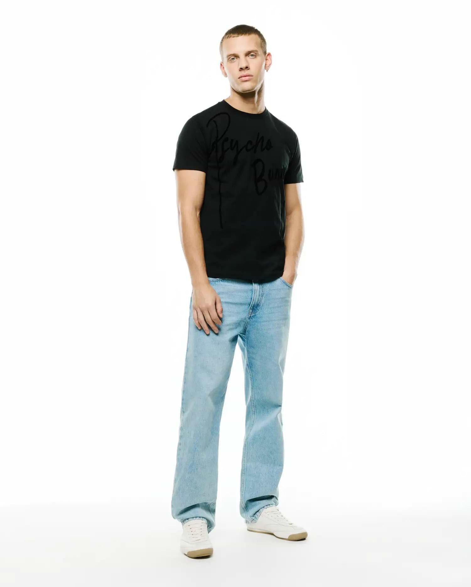 Mens Soren Graphic Tee, a black classic fit jersey t-shirt featuring a prominent, large tonal black Psycho Bunny script logo graphic across the chest, embodying refined streetwear style. (5)