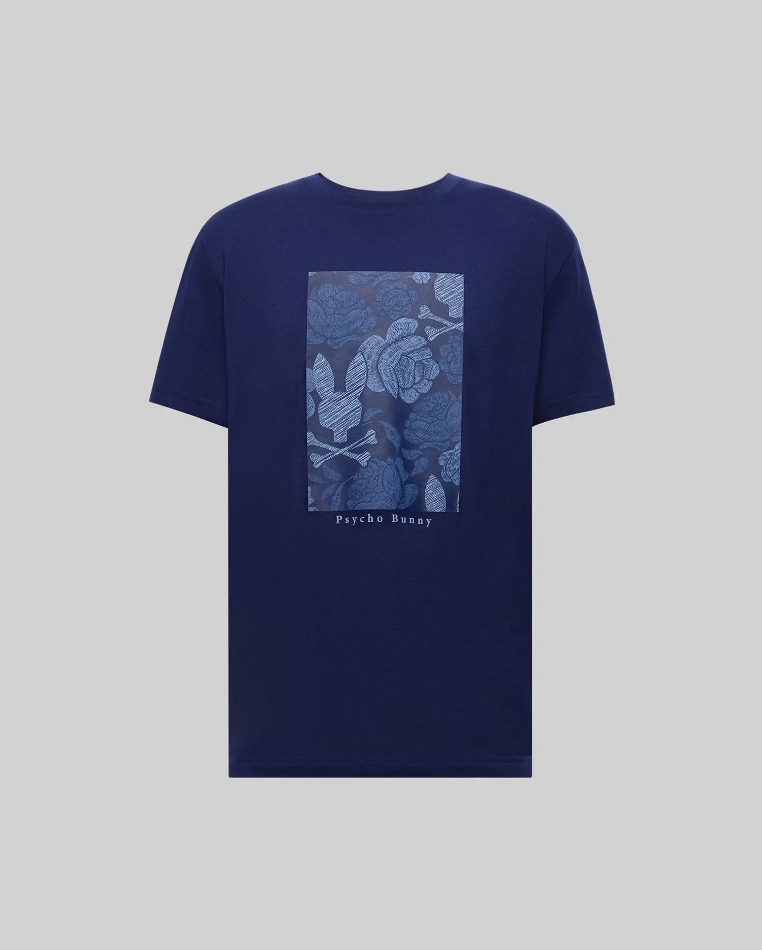 The MENS ROWEN OVERSIZED TEE (MT0200194) by Psycho Bunny is a navy blue Pima cotton t-shirt with a floral graphic, rectangular bunny logo, and "Psycho Bunny" text on the back, designed for a relaxed fit. (5)