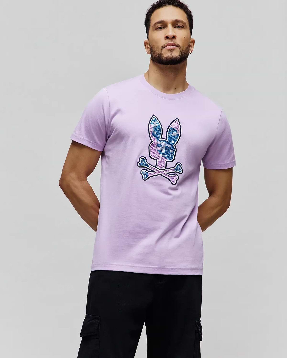 Olivier Graphic Tee, a classic fit lavender jersey t-shirt featuring a large, centered pixelated blue and pink camo Psycho Bunny skull logo. (2)