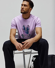 Mens Olivier Graphic Tee, a classic fit lavender jersey t-shirt featuring a large, pixelated purple and blue digital camo Psycho Bunny skull and crossbones logo centered on the chest. (4)
