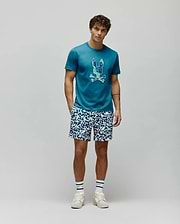 Mens Olivier Graphic Tee in teal jersey knit, featuring a classic fit and a large, pixelated blue and green Psycho Bunny skull logo prominently displayed on the chest. (5)