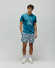 Mens Olivier Graphic Tee in teal jersey knit, featuring a classic fit and a large, pixelated blue and green Psycho Bunny skull logo prominently displayed on the chest. (5)