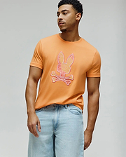 Mens Olivier Graphic Tee, vibrant orange classic fit jersey knit t-shirt featuring a large, central Psycho Bunny skull logo with a pink-to-yellow gradient and white outline. (2)