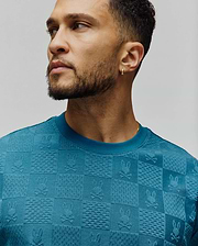 Mens Dustin Oversized Tee in teal, featuring an all-over jacquard checkerboard pattern with embossed Psycho Bunny skull logos and varied textured squares, in a soft knit. (3)