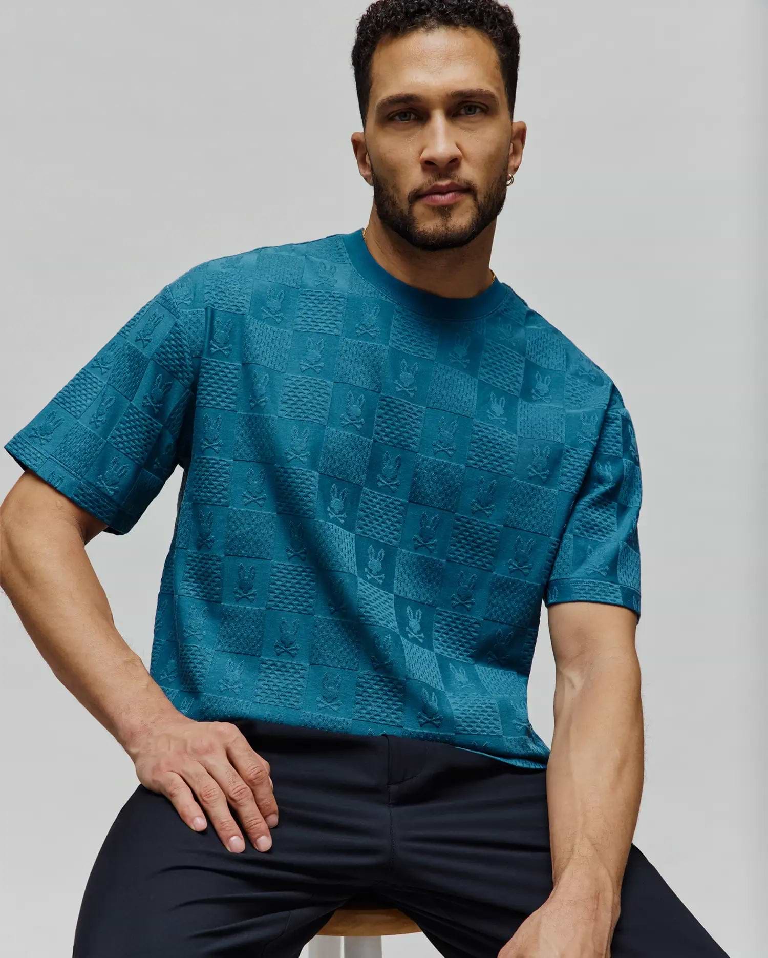 Mens Dustin Oversized Tee in deep teal, featuring a relaxed fit and an all-over tonal embossed checkerboard pattern with Psycho Bunny skull logos. (2)