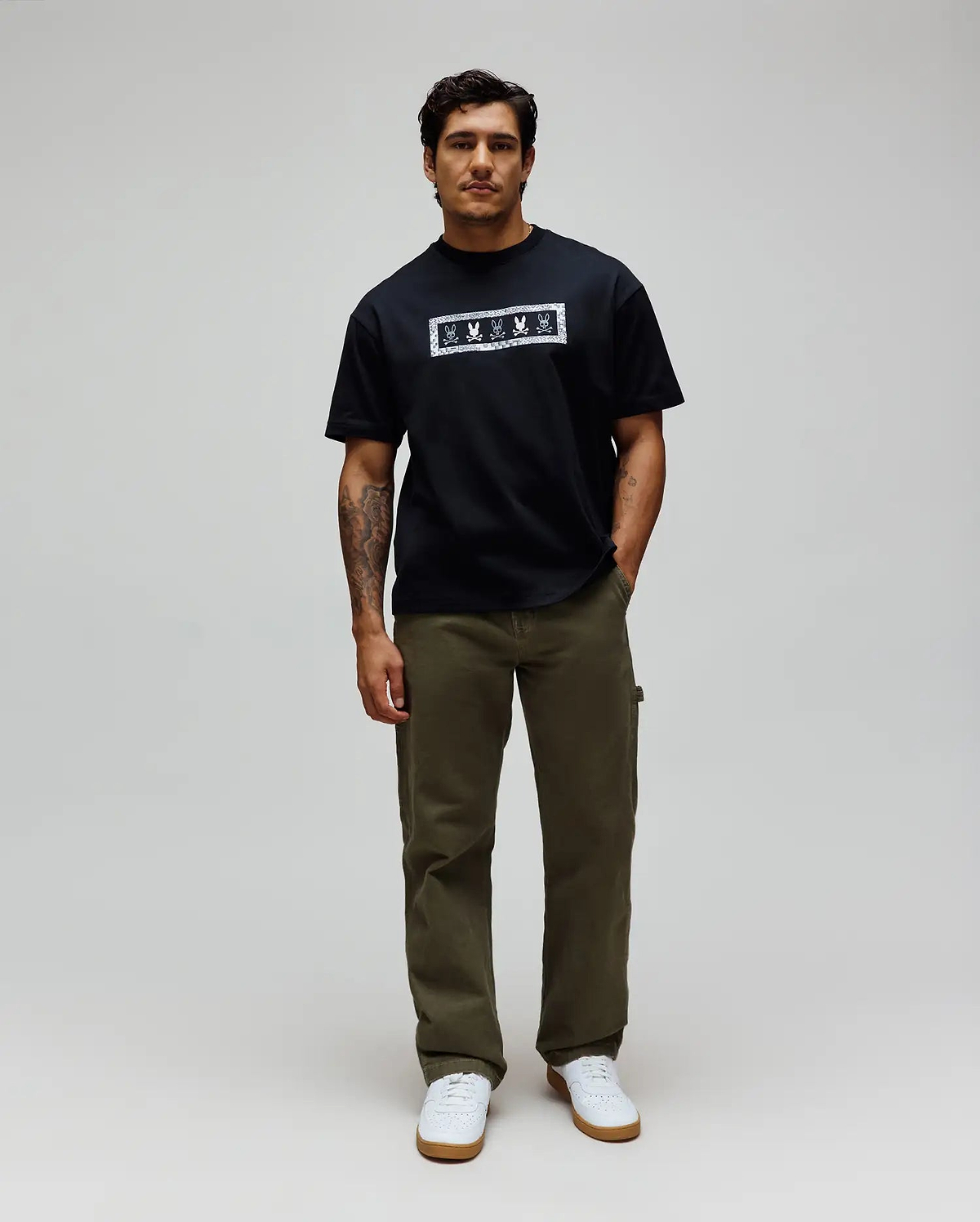 Black Mens Olivier Oversized Tee in soft jersey, featuring a prominent white rectangular chest graphic with repeated Psycho Bunny skull logos and a patterned border. (3)