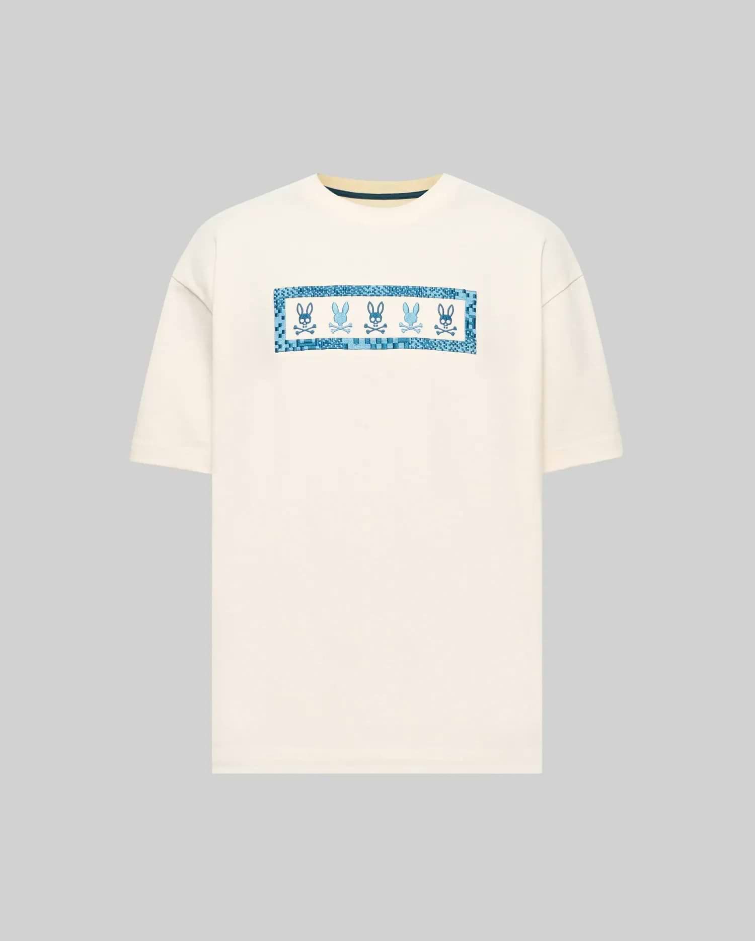 Mens Olivier Oversized Tee in cream, featuring a central chest graphic with multiple blue Psycho Bunny skull logos framed by a pixelated blue border. Smooth jersey knit, oversized fit. (4)
