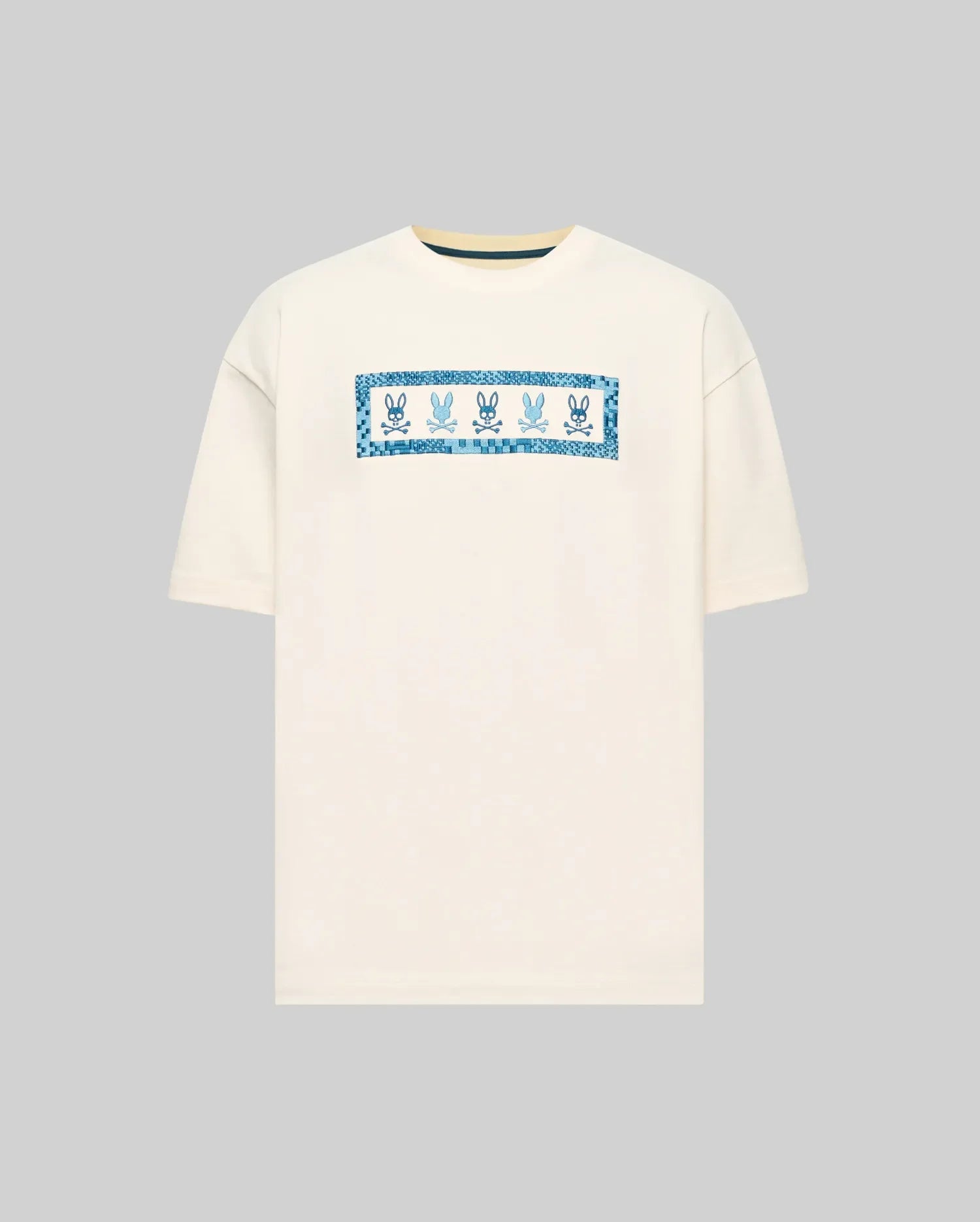 Mens Olivier Oversized Tee in cream, featuring a central chest graphic with multiple blue Psycho Bunny skull logos framed by a pixelated blue border. Smooth jersey knit, oversized fit. (4)
