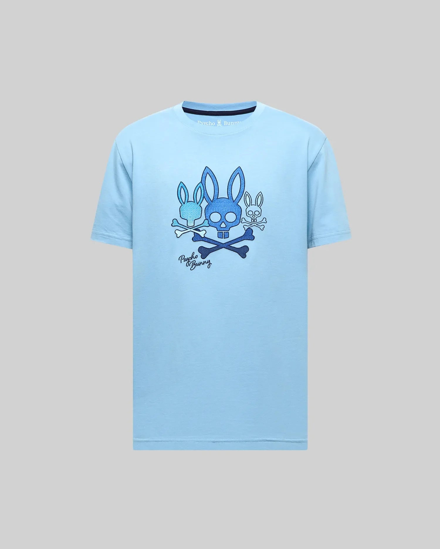 Mens Oscar Graphic Tee, light blue classic fit jersey t-shirt featuring a large chest graphic of three blue Psycho Bunny skull and crossbones logos, script, and dark blue collar trim. (2)