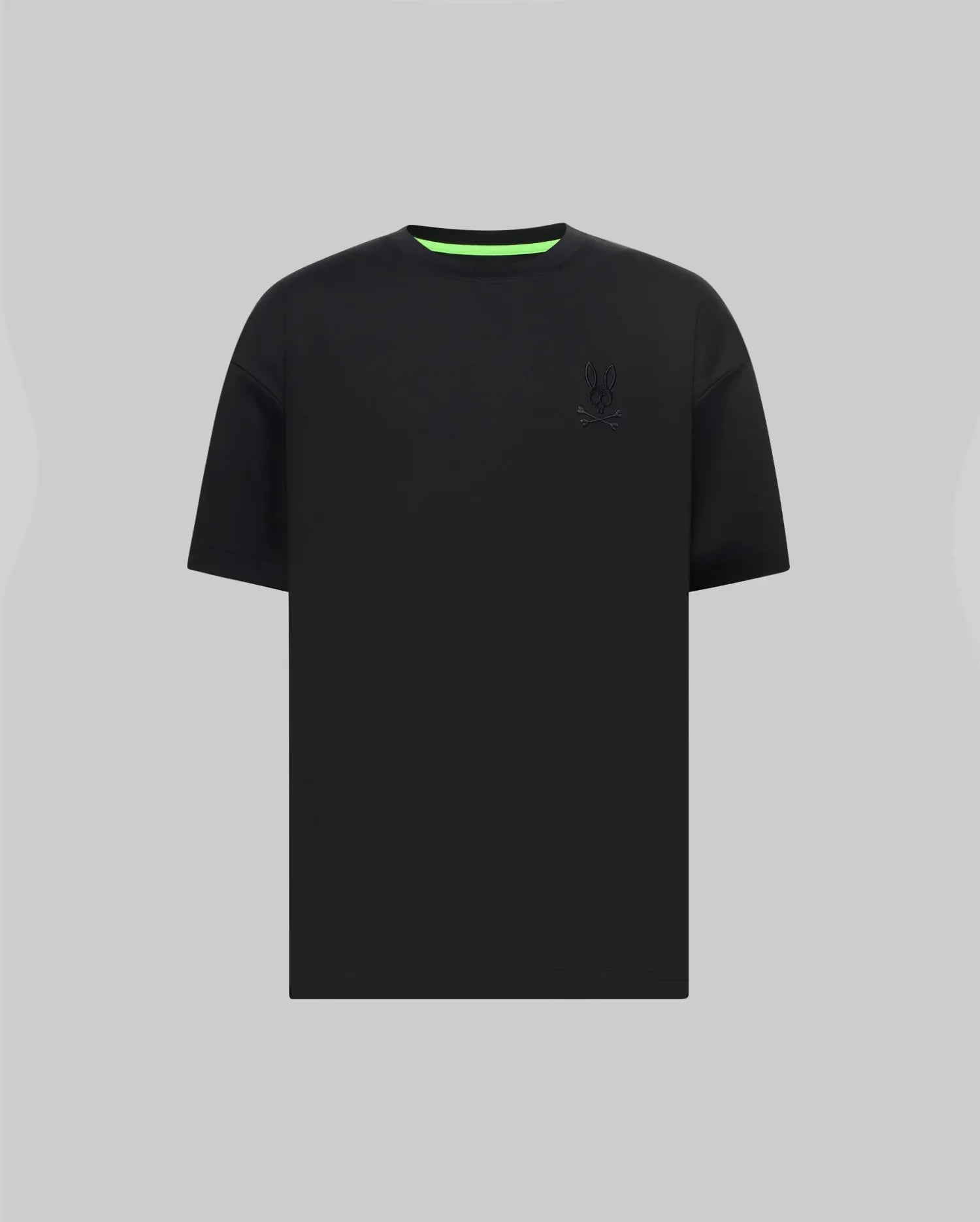 Mens Oscar Oversized Tee, black jersey knit with a relaxed fit, featuring a tonal embroidered Psycho Bunny skull logo on the left chest and a vibrant neon green inner collar.