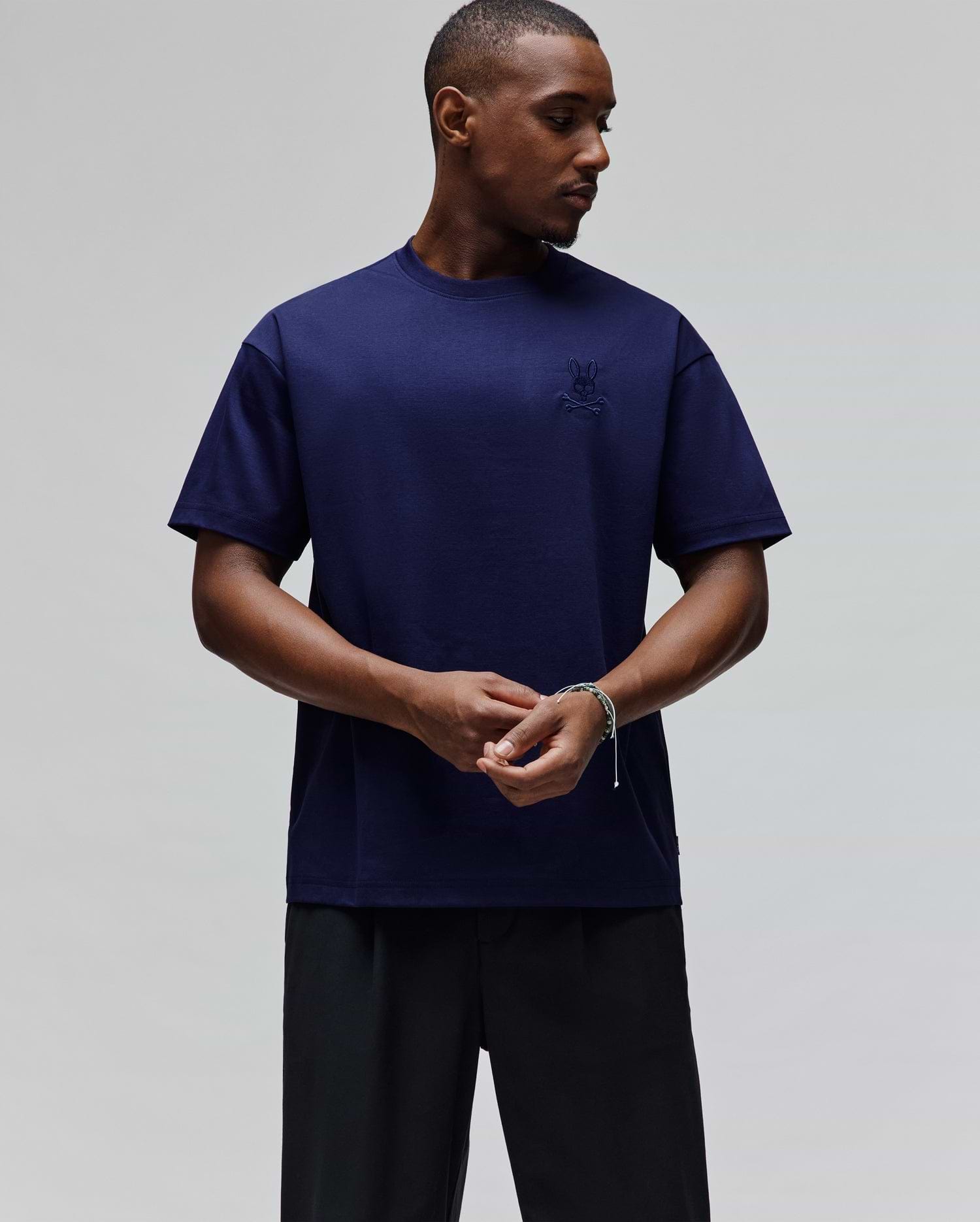 Mens Oscar Oversized Tee in deep navy blue, featuring a small, tonal embroidered Psycho Bunny skull logo on the left chest, crafted from smooth jersey fabric for a relaxed fit.