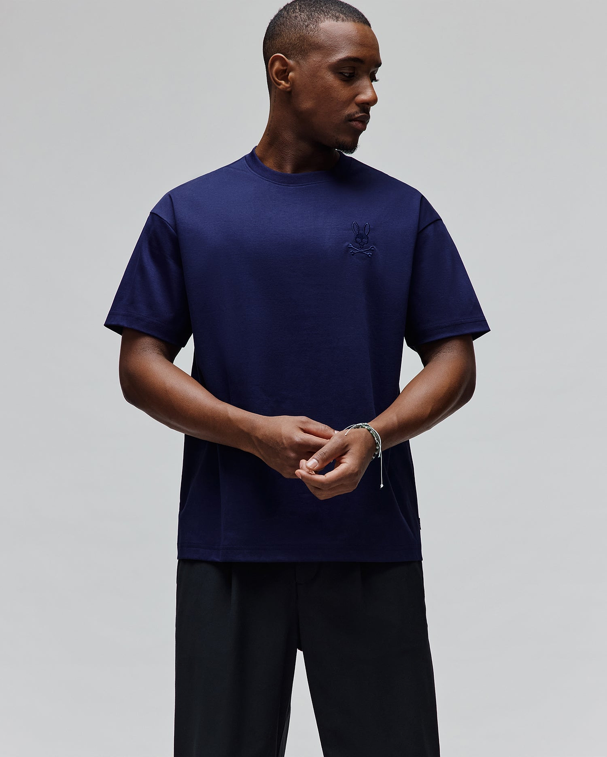 Mens Oscar Oversized Tee in deep navy blue, featuring a small, tonal embroidered Psycho Bunny skull logo on the left chest, crafted from smooth jersey fabric for a relaxed fit.