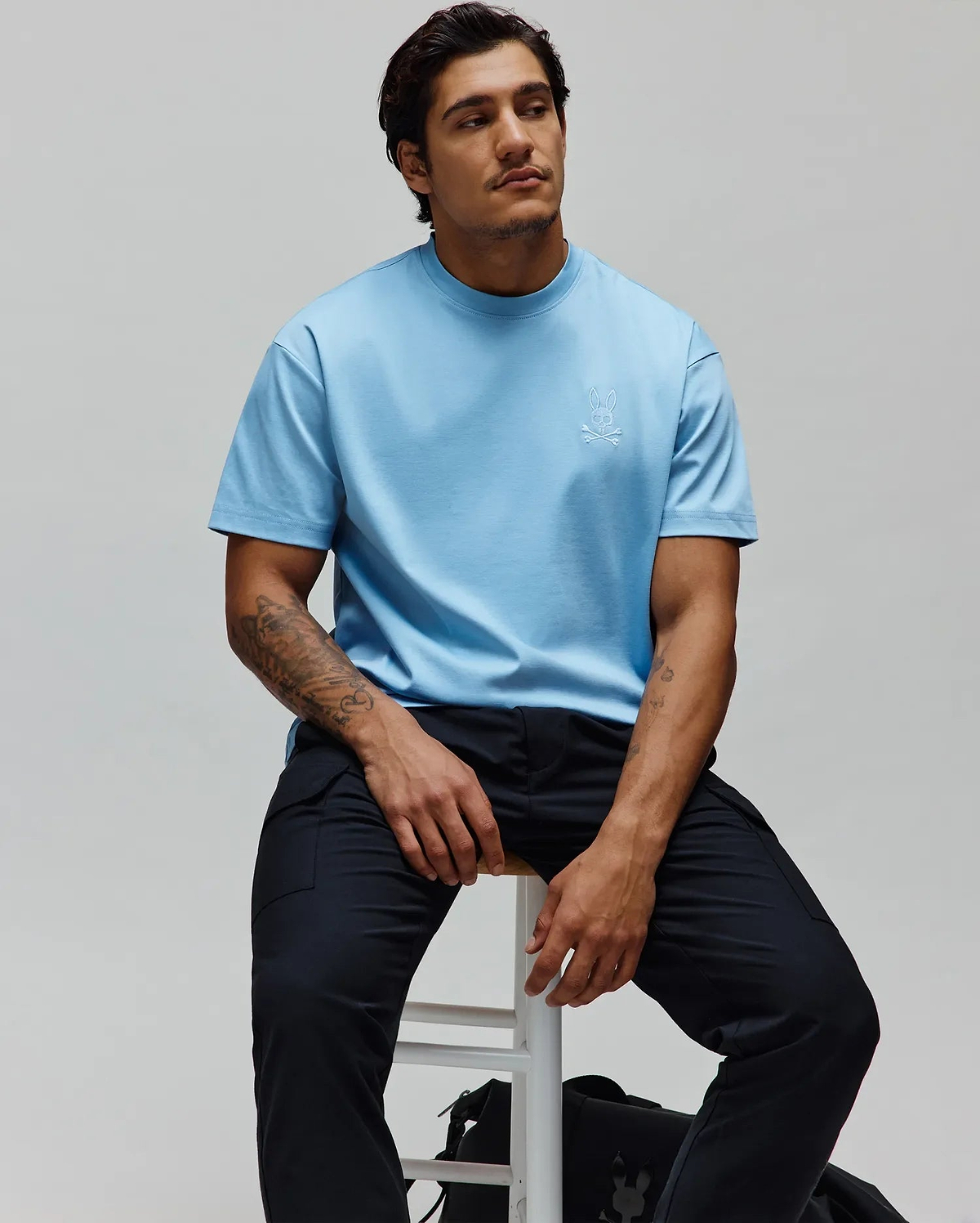 Mens Oscar Oversized Tee in light blue jersey knit, featuring a small white embroidered Psycho Bunny skull logo on the left chest, with a relaxed fit.