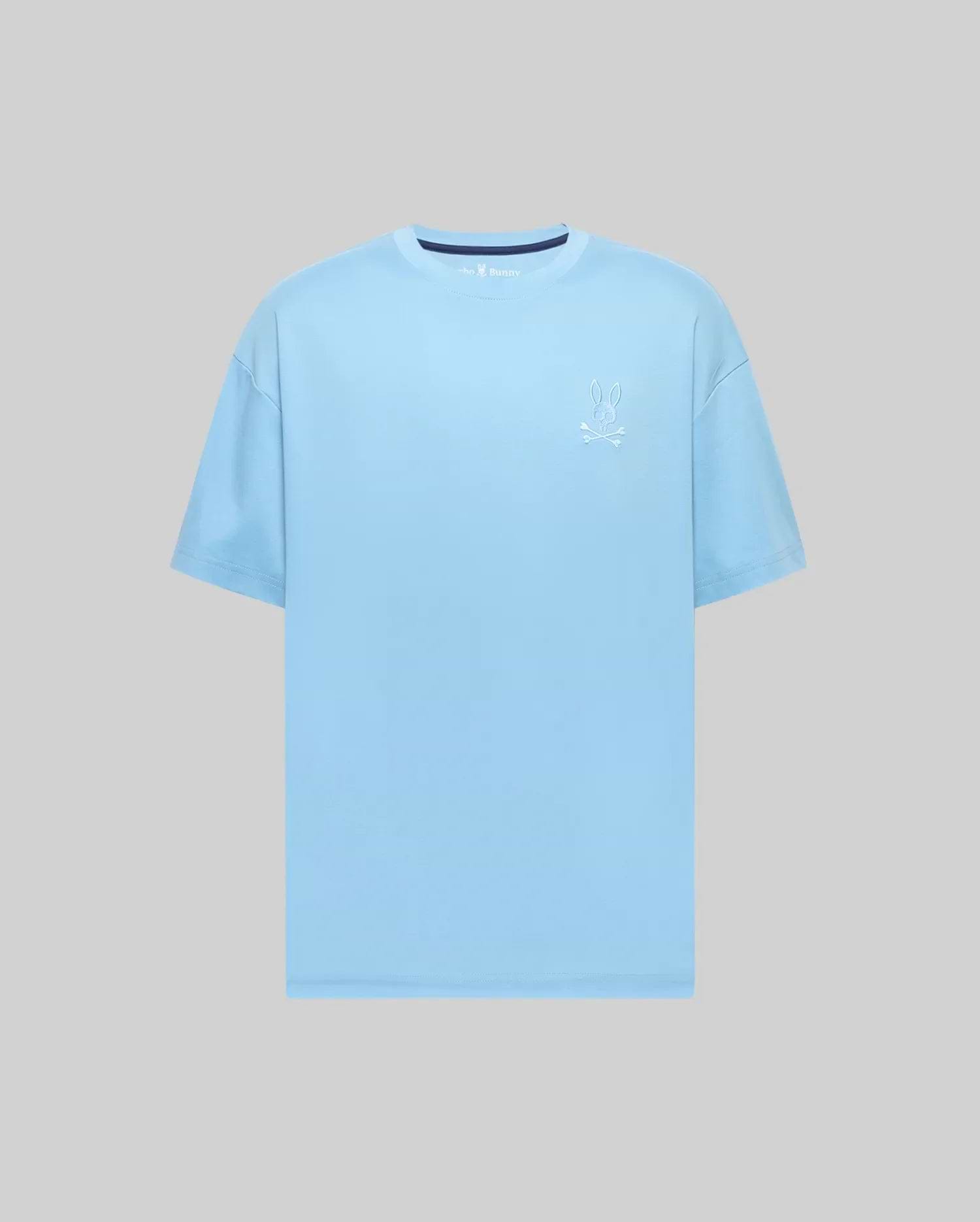 Mens Oscar Oversized Tee, a sky blue smooth jersey knit t-shirt with a white embroidered Psycho Bunny skull logo on the left chest and a subtle navy inner collar detail.