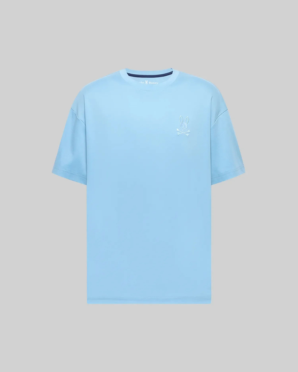 Mens Oscar Oversized Tee, a sky blue smooth jersey knit t-shirt with a white embroidered Psycho Bunny skull logo on the left chest and a subtle navy inner collar detail.
