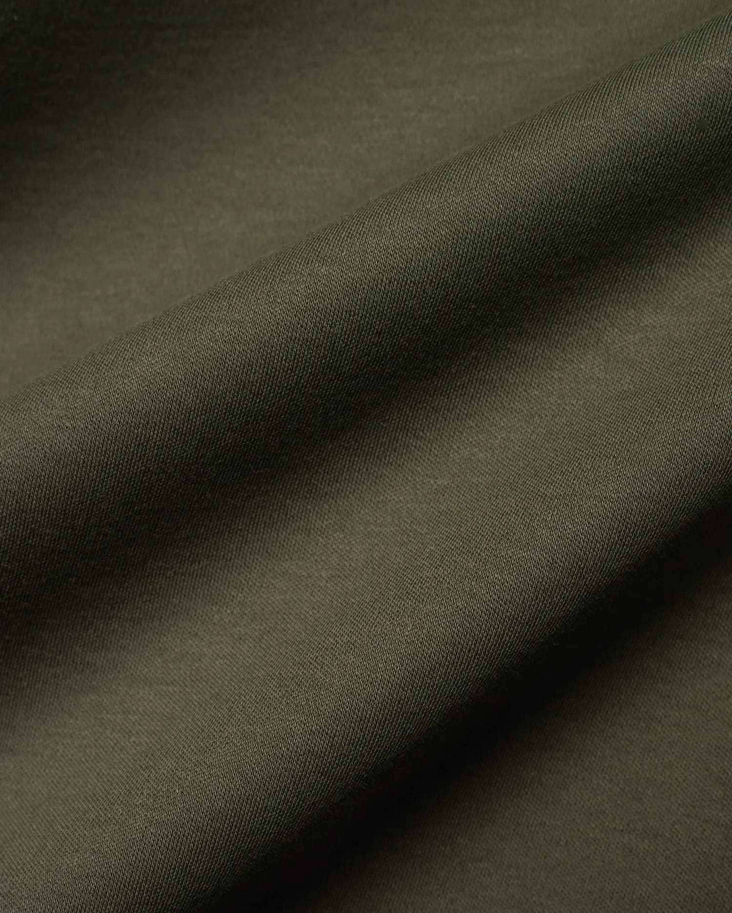 Mens Oscar Relaxed Fit Tee in deep, earthy olive green, showcasing a finely woven, subtly textured pique knit fabric, ideal for premium streetwear comfort.