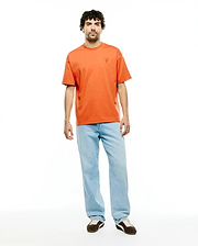 Men's Oscar Oversized Tee, a vibrant orange jersey t-shirt with an oversized fit, featuring a small, tonal embroidered Psycho Bunny skull logo on the left chest. (4)