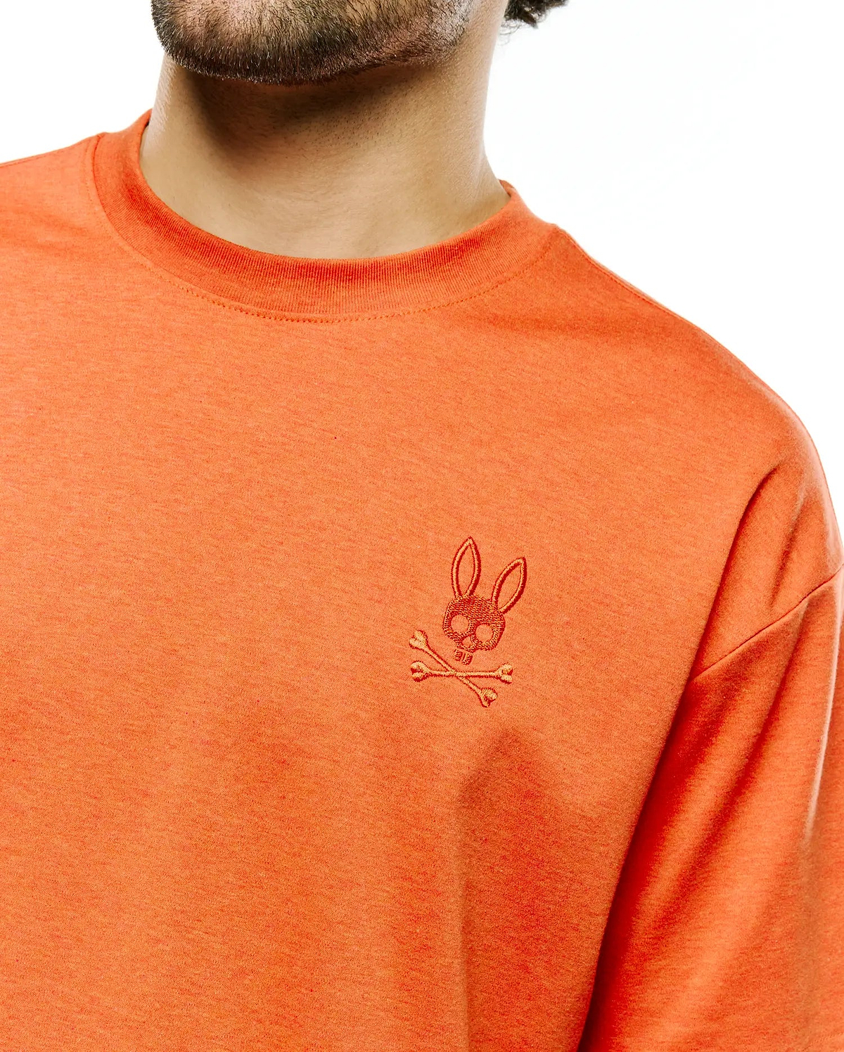 Men's Oscar Oversized Tee in heathered orange jersey knit, featuring a small, tonal embroidered Psycho Bunny skull and crossbones logo on the left chest. (2)