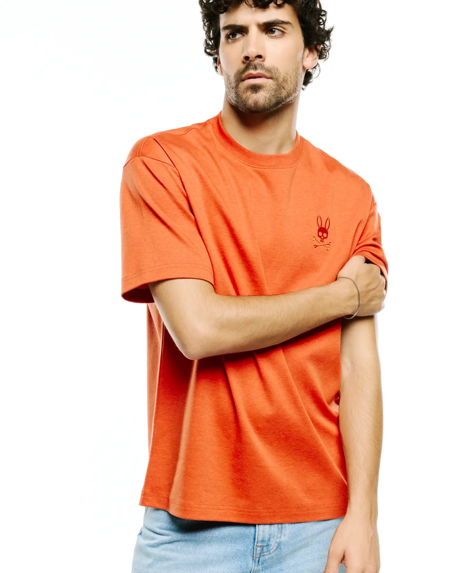 Men's Oscar Oversized Tee, a heathered orange, soft jersey knit t-shirt featuring a small, tonal embroidered Psycho Bunny skull logo on the left chest. (3)
