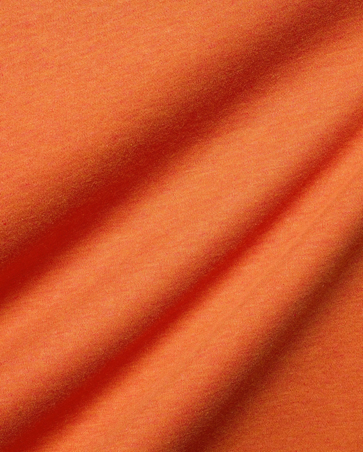 Men's Oscar Oversized Tee, a premium streetwear staple in vibrant heathered orange, crafted from soft jersey knit fabric with natural folds, offering a comfortable, relaxed fit. (6)