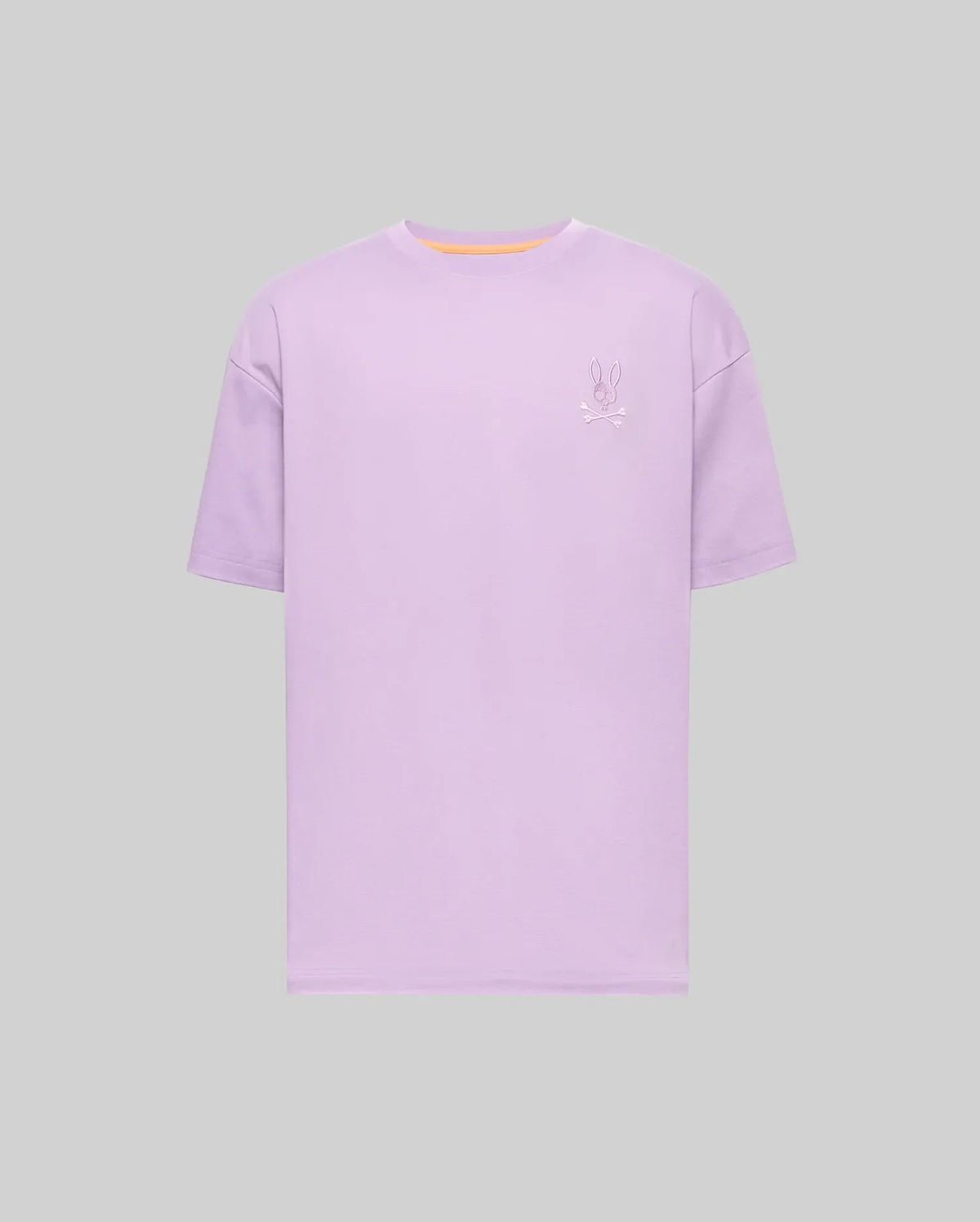Mens Oscar Oversized Tee, a lavender oversized jersey t-shirt featuring a small embroidered Psycho Bunny skull logo on the left chest and a subtle orange neckline trim. (4)