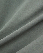 Mens Oscar Oversized Tee, a premium sage green jersey knit fabric with a soft, smooth handfeel and subtle texture, showcasing a relaxed fit and refined streetwear aesthetic.