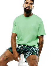 Mens Oscar Relaxed Fit Tee in light green, a smooth jersey knit with a relaxed fit, featuring a small, embroidered white Psycho Bunny skull and crossbones logo on the left chest.