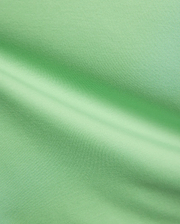 Mens Oscar Relaxed Fit Tee in a fresh, vibrant light green, premium soft jersey knit fabric, highlighting its smooth, breathable texture and elegant, relaxed drape with subtle folds and shadows.
