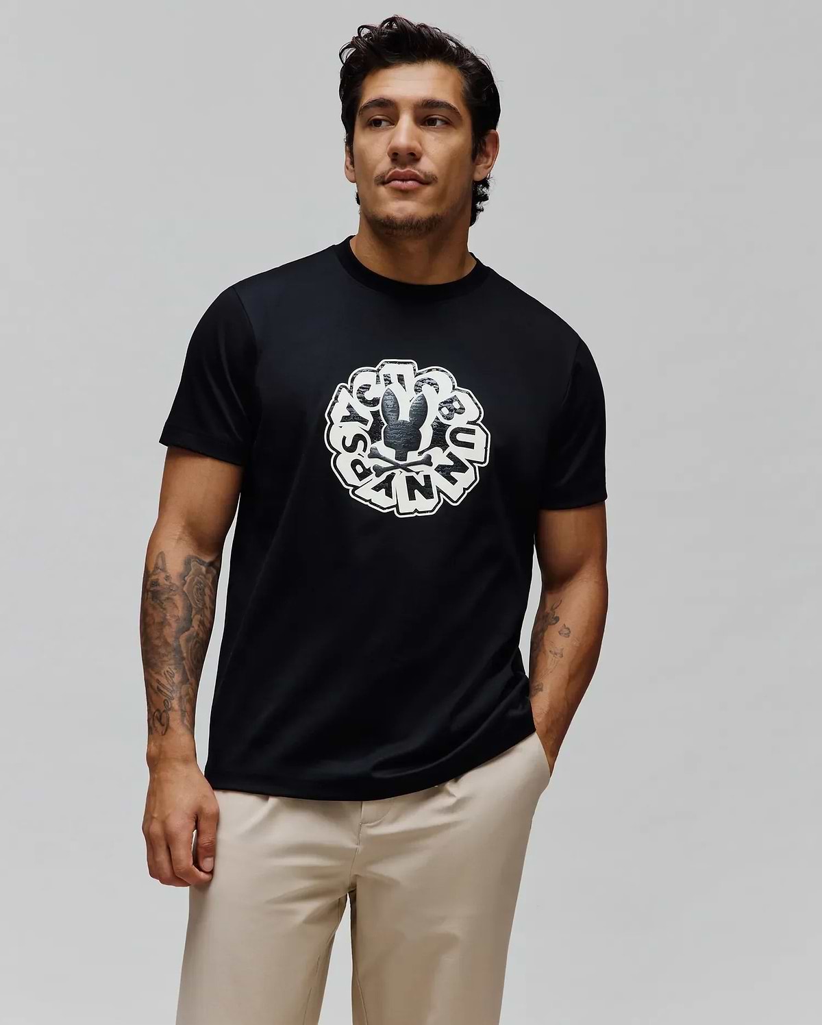 Mens Toby Graphic Tee, black classic fit jersey knit featuring a large distressed white circular Psycho Bunny skull logo and brand name graphic on the center chest.