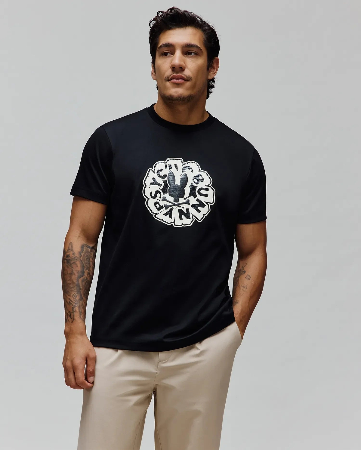 Mens Toby Graphic Tee, black classic fit jersey knit featuring a large distressed white circular Psycho Bunny skull logo and brand name graphic on the center chest.