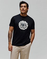Mens Toby Graphic Tee, black classic fit jersey knit featuring a large distressed white circular Psycho Bunny skull logo and brand name graphic on the center chest.