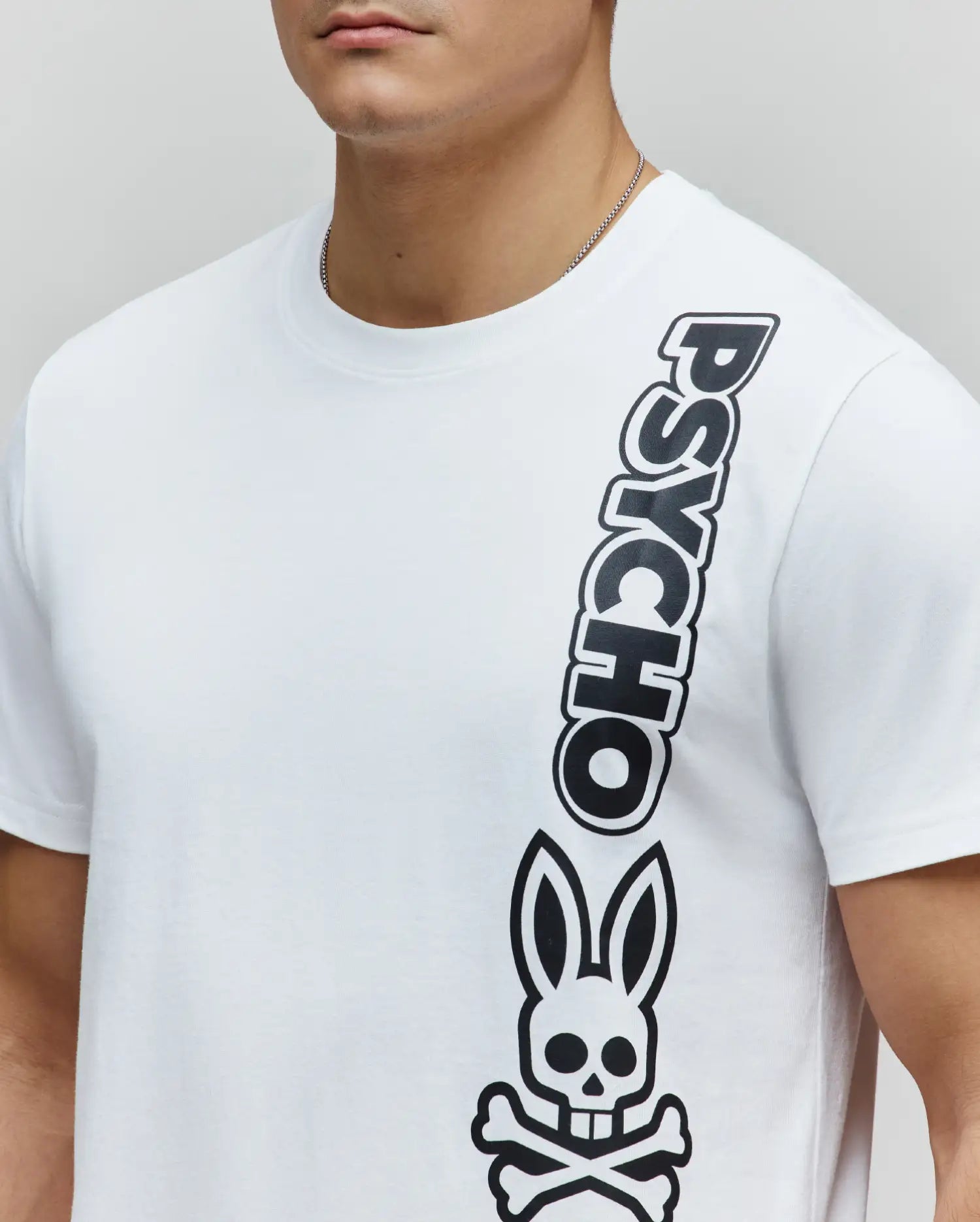 Mens Toby Wordmark Tee, a classic fit white jersey t-shirt featuring a large, vertical black Psycho wordmark and iconic bunny skull logo graphic on the right side. (2)